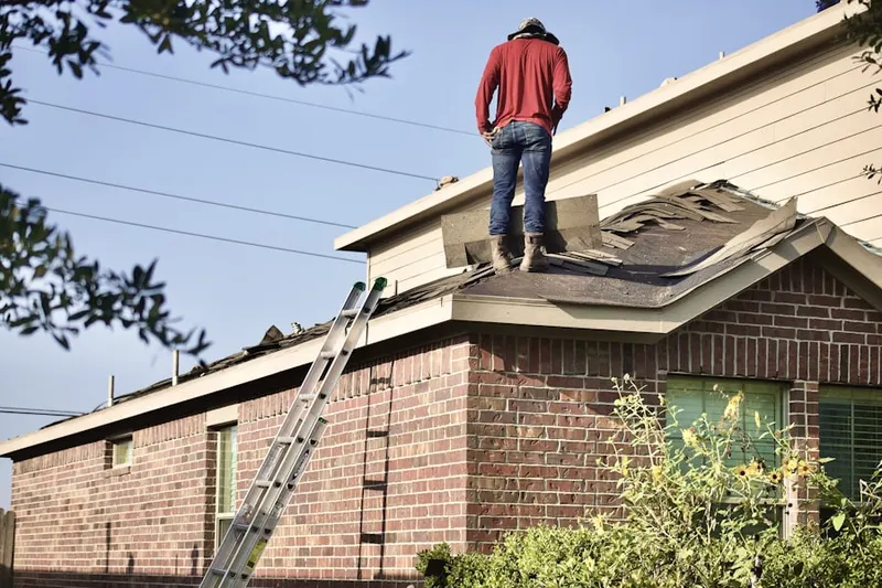 Professional roofer working on a residential roof in De Soto